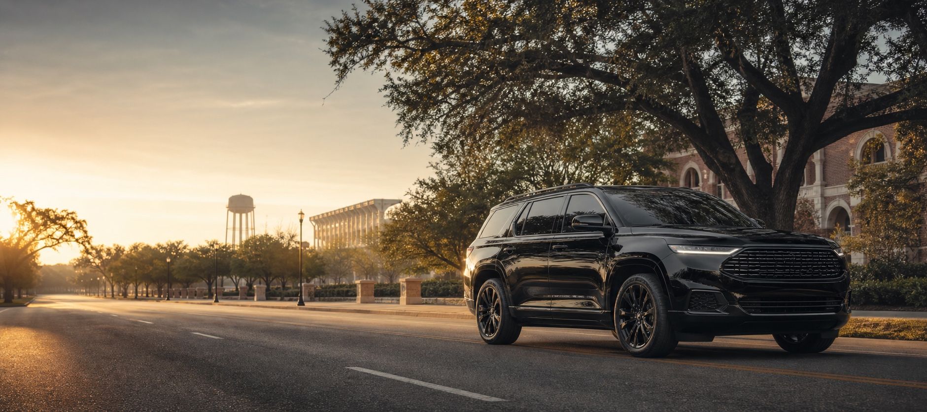 Illustrative black vehicle on a tree-lined Texas road at golden hour